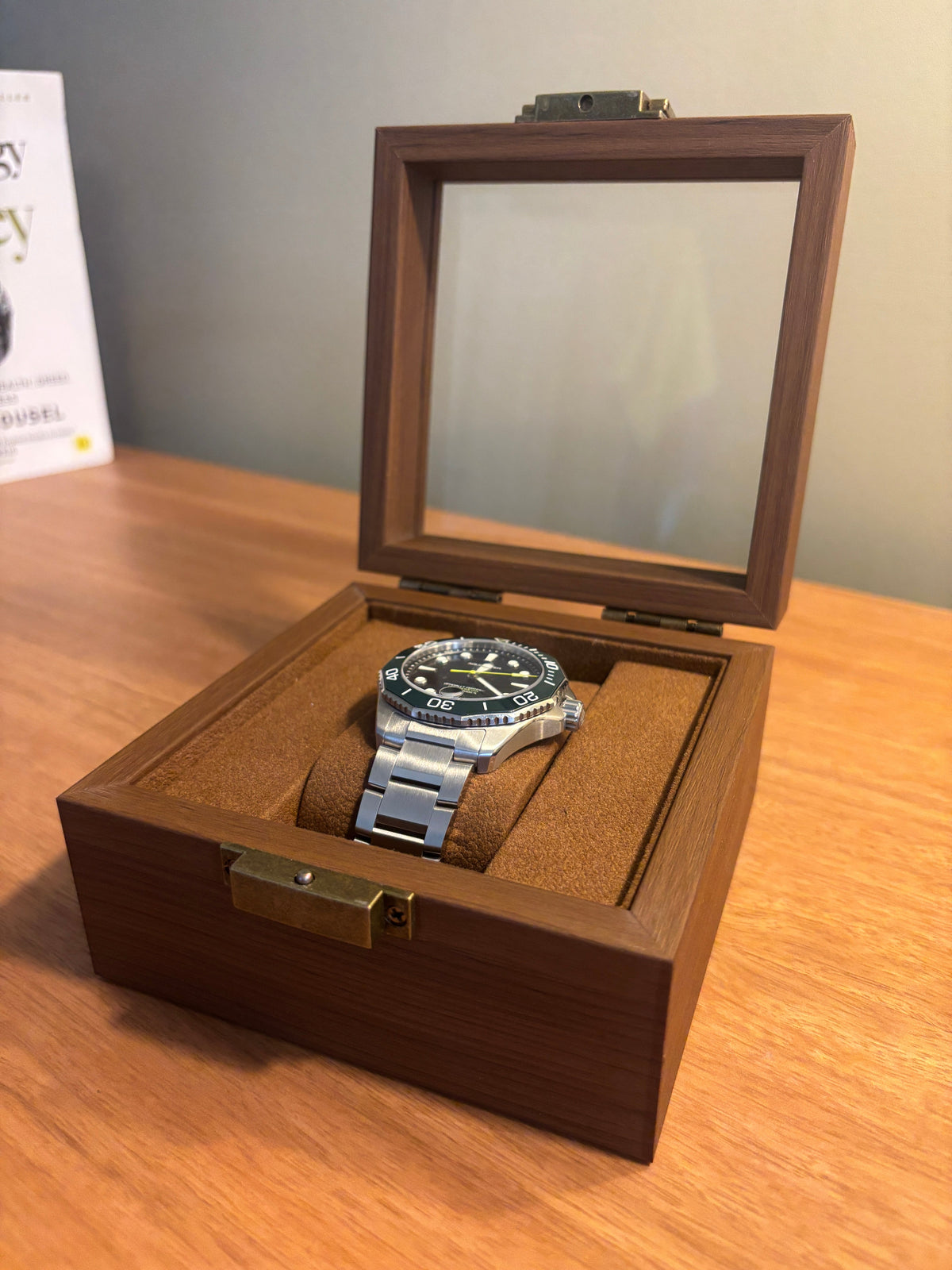 Open watch display box with multiple watches stored inside on cushioned slots