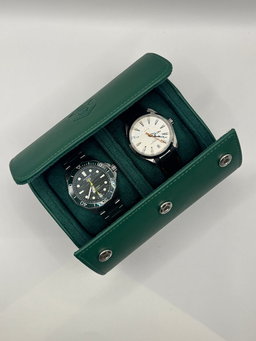 Augusta Green vegan leather watch roll shown flat on a wooden surface